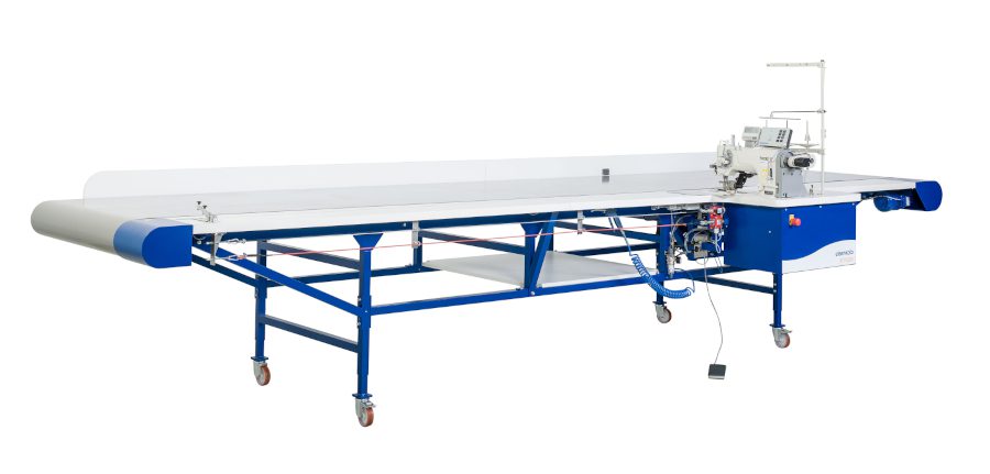 Eisenkolb DCP 2300 double needle conveyor sewing machine in a curtain workroom